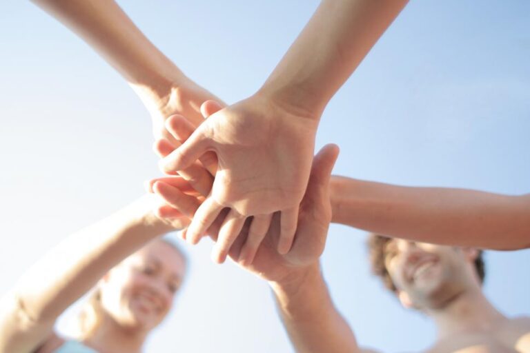 Hands stacking on top of each other in a group