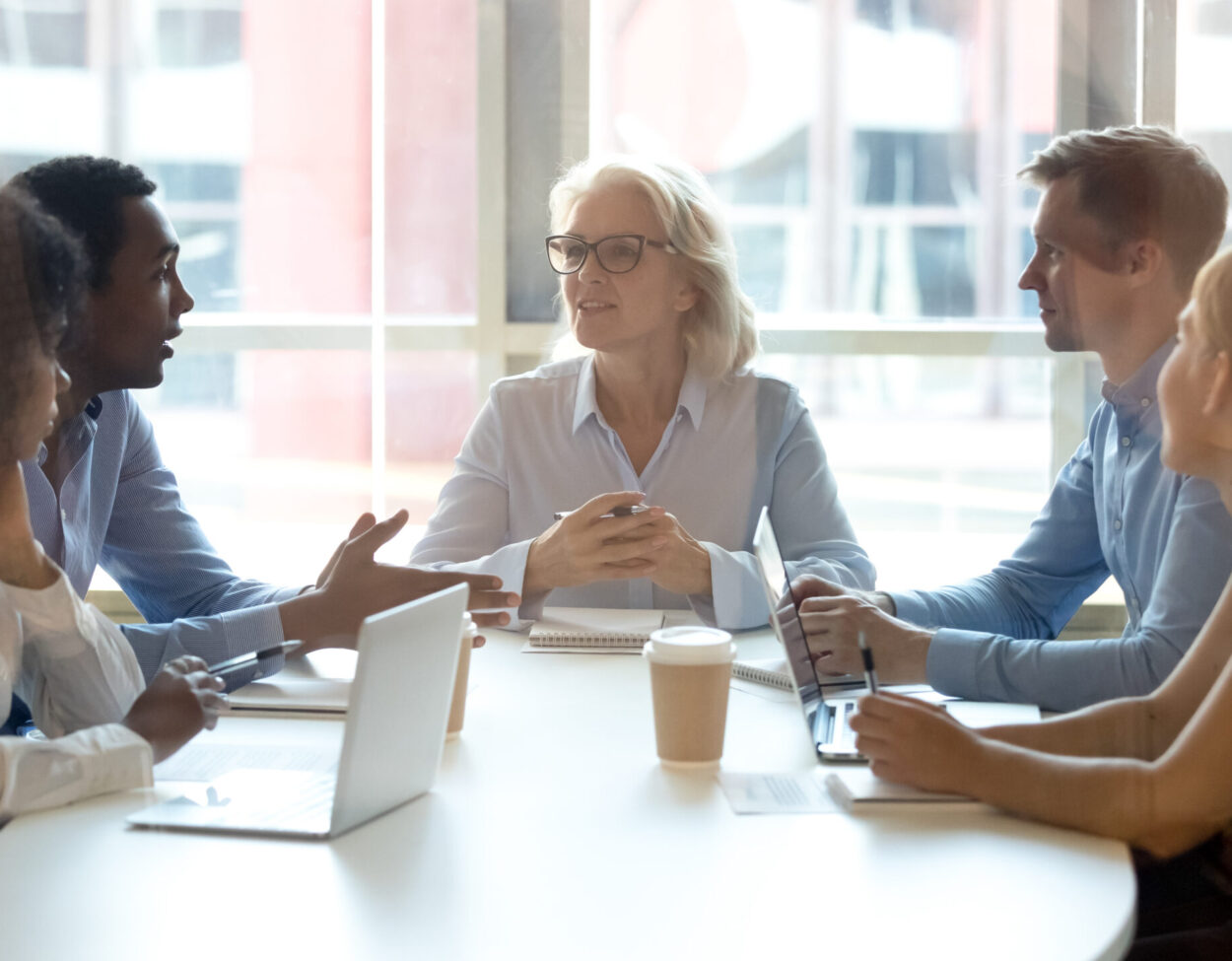 men and women in a group meeting room